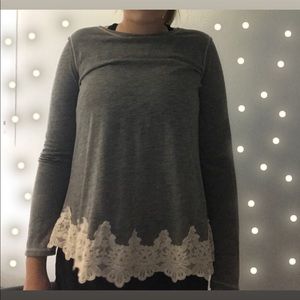 grey sweater with white embroidery on bottom